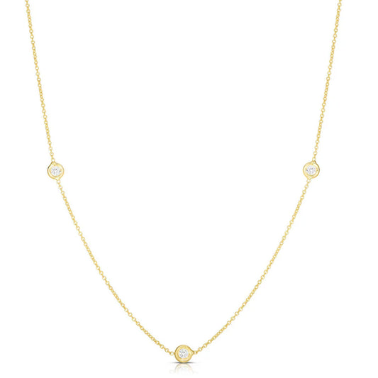 The Roberto Coin Diamonds By The Inch 18K Yellow Gold 3 Station Necklace features three round diamonds set along a fine chain, shown on a white background.