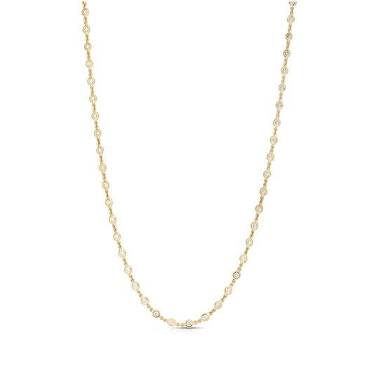 The Roberto Coin Diamonds By The Inch 18K Yellow Gold Station Necklace, adorned with small, regularly placed round diamond accents along its length, is showcased against a plain white background.