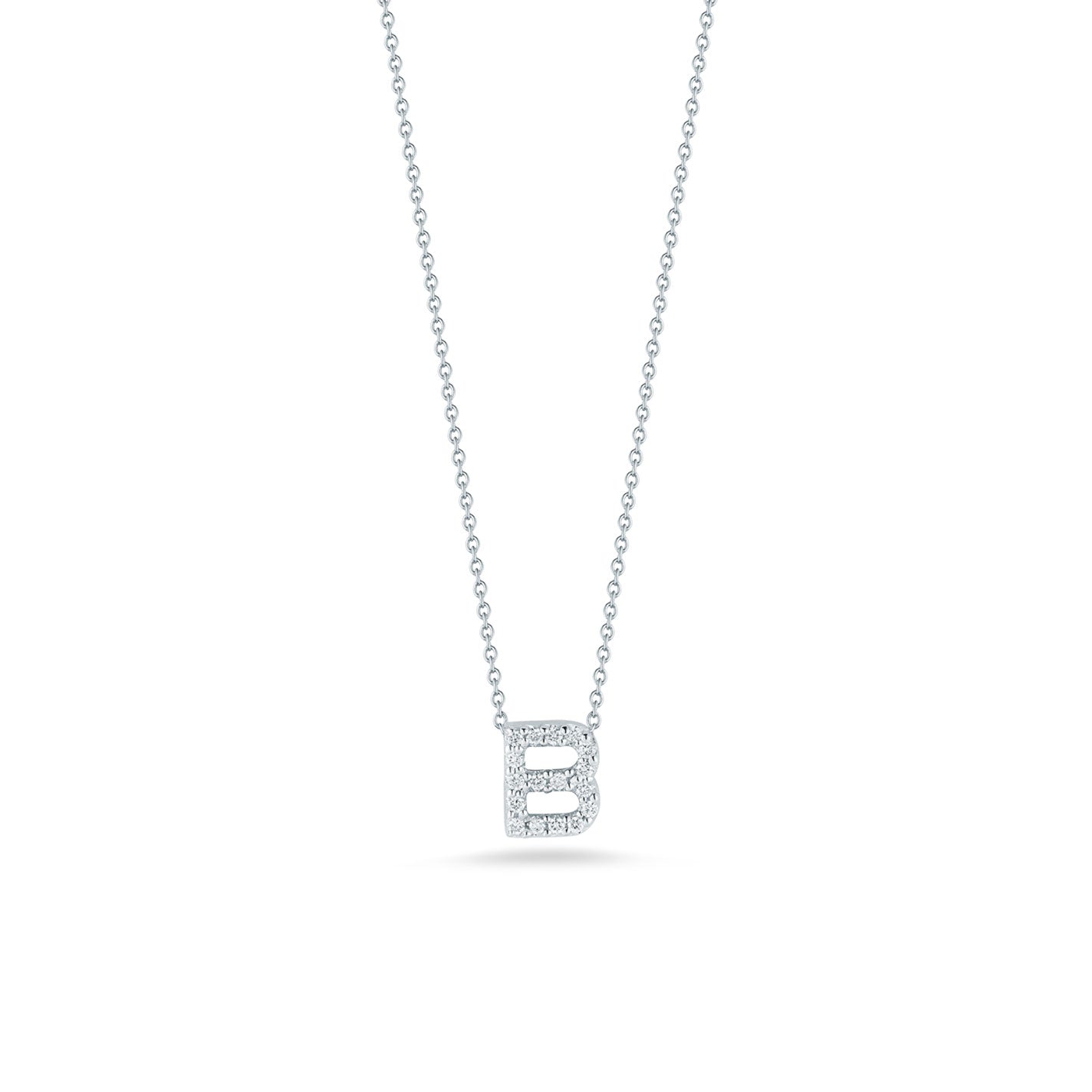 The Roberto Coin Tiny Treasures Love Letter Initial Necklace Pendant features a dainty 18 karat white gold chain highlighting a sparkling initial 'B'. This elegant piece is accented with small diamonds totaling 0.06 carats, making its brilliance stand out against a simple white backdrop.