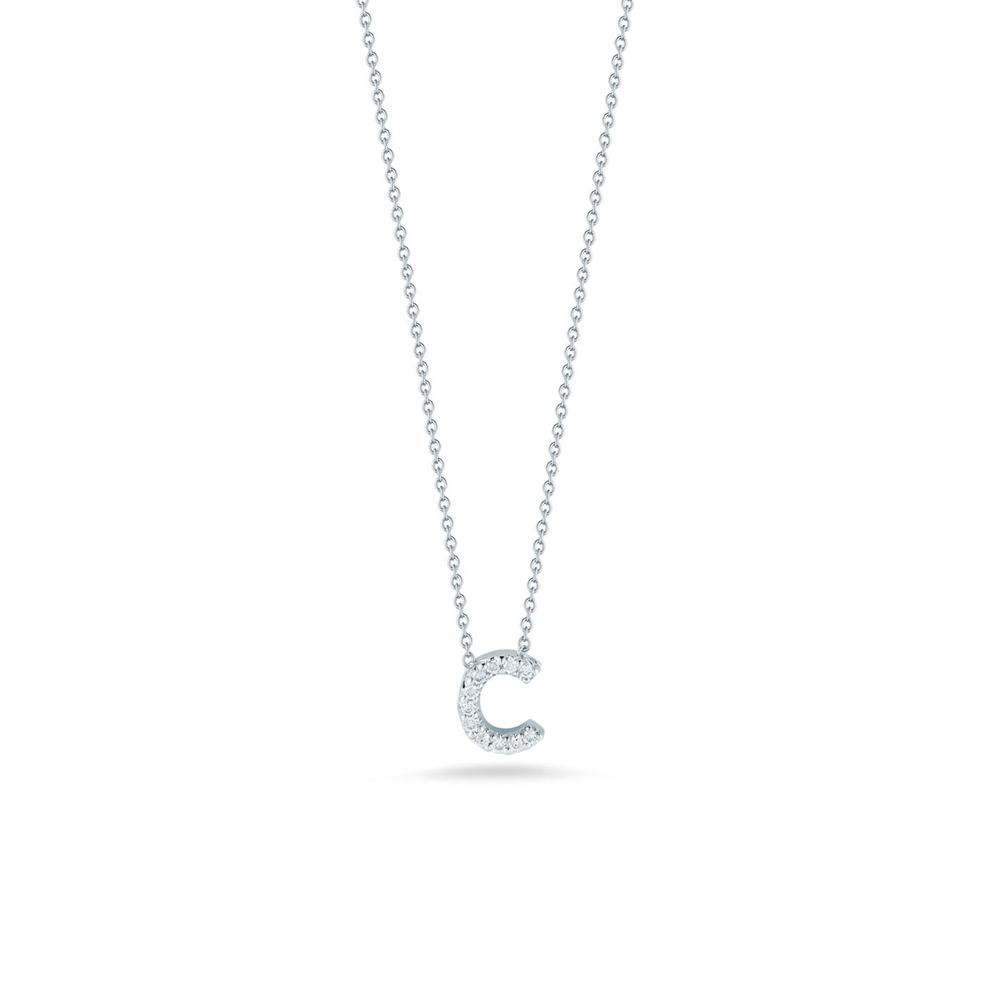 The Roberto Coin Tiny Treasures Love Letter necklace features an initial pendant crafted from 18 karat white gold in the shape of "C," embellished with sparkling diamonds. The thin chain and pendant exhibit a sleek silver color against a plain white background.