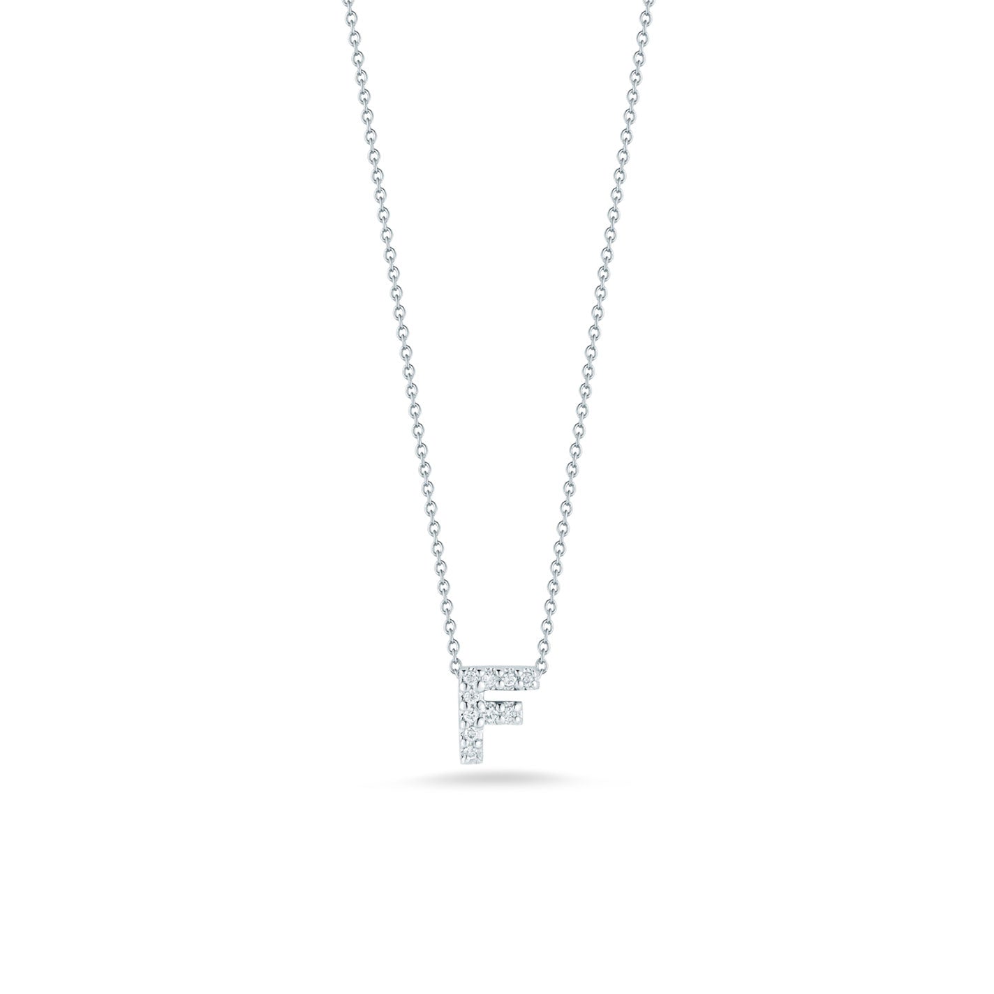 The Roberto Coin Tiny Treasures 18K White Gold Diamond Initial Necklace Pendant showcases a delicate 'F' initial, crafted from 18 Karat White Gold and adorned with glittering round diamonds. Set against a simple white backdrop, this exquisite piece of jewelry epitomizes elegance.