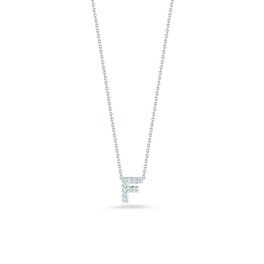 The Roberto Coin Tiny Treasures 18K White Gold Diamond Initial Necklace Pendant showcases a delicate 'F' initial, crafted from 18 Karat White Gold and adorned with glittering round diamonds. Set against a simple white backdrop, this exquisite piece of jewelry epitomizes elegance.