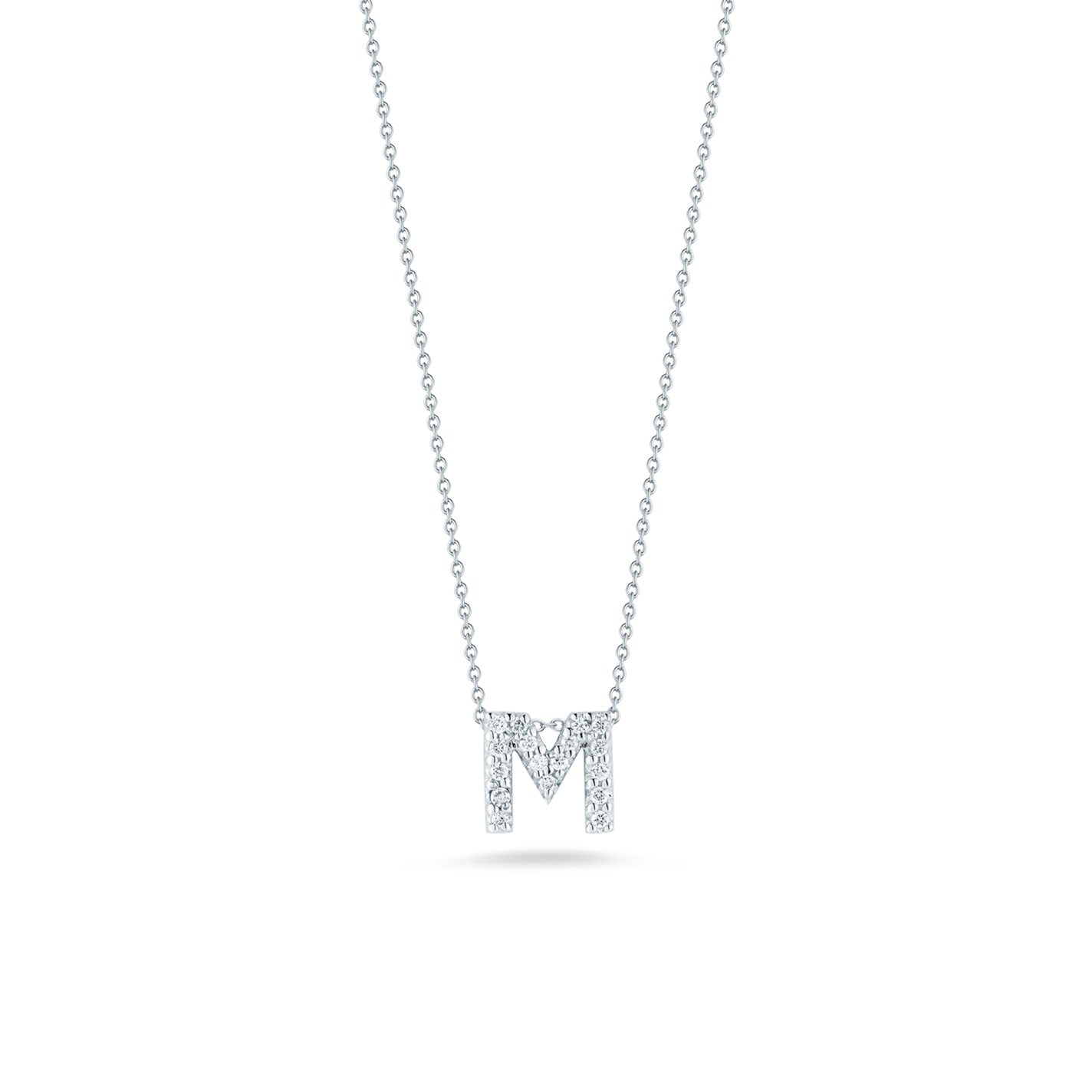 The Roberto Coin Tiny Treasures 18K White Gold Diamond Initial Necklace Pendant is a stunning piece, featuring an "M" shaped pendant encrusted with small diamonds. Crafted in 18 Karat White Gold, it hangs elegantly from a delicate chain against a plain white background.