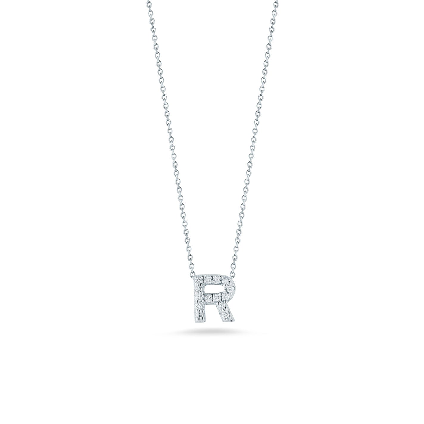 The Roberto Coin Tiny Treasures 18K White Gold Diamond Initial Necklace Pendant features an elegant design by Roberto Coin, showcasing a beautifully crafted letter "R" pendant encrusted with small, shining diamonds, set against a plain white background.