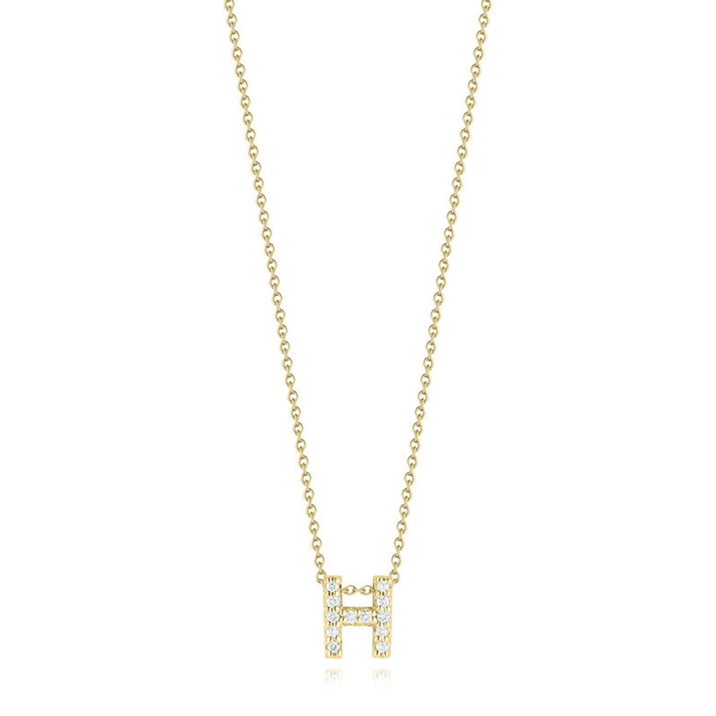 The Roberto Coin Tiny Treasures Love Letter necklace features an 18K yellow gold pendant adorned with a small, diamond-studded letter "H," elegantly suspended on a gold chain against a white background.