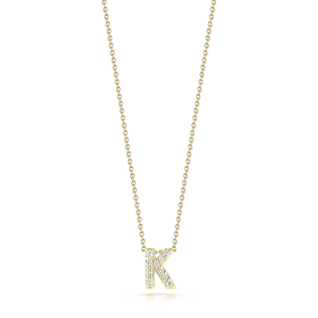 The Roberto Coin Tiny Treasures Love Letter 18K Yellow Gold Diamond Initial Necklace Pendant showcases a pendant shaped as the letter "K," adorned with small sparkling diamonds. Its slender 18″ chain, crafted by renowned brand Roberto Coin, perfectly accentuates the sophisticated design, enhancing its overall allure.