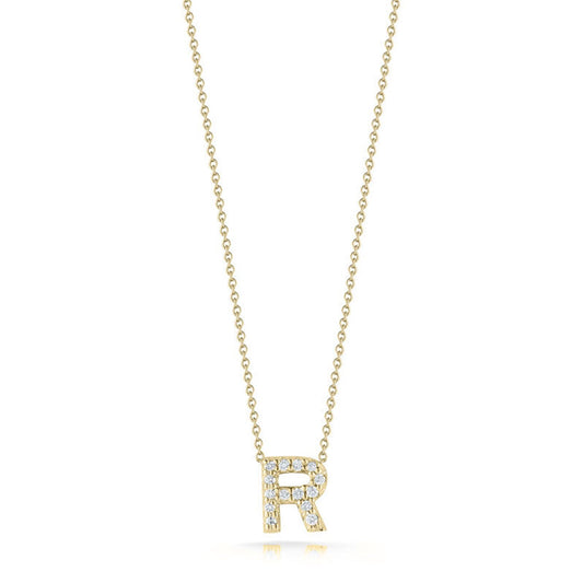 Introducing the Roberto Coin Tiny Treasures Love Letter 18K Yellow Gold Diamond Initial Necklace Pendant: a stunning piece from the renowned brand Roberto Coin. This exquisite necklace showcases a pendant in the shape of the letter "R," elegantly adorned with small diamonds. The pendant gracefully dangles from a delicate gold chain, all presented against a simple, elegant white backdrop.