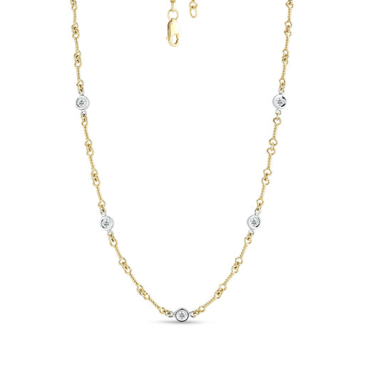 Introducing the Roberto Coin Diamonds By The Inch 18K Yellow and White Gold Station Necklace. This elegant piece, crafted by Roberto Coin, showcases small round diamond accents meticulously placed along the chain. Designed with a lobster clasp closure at the top, this necklace exudes simplicity and sophistication, making it perfect for any occasion.