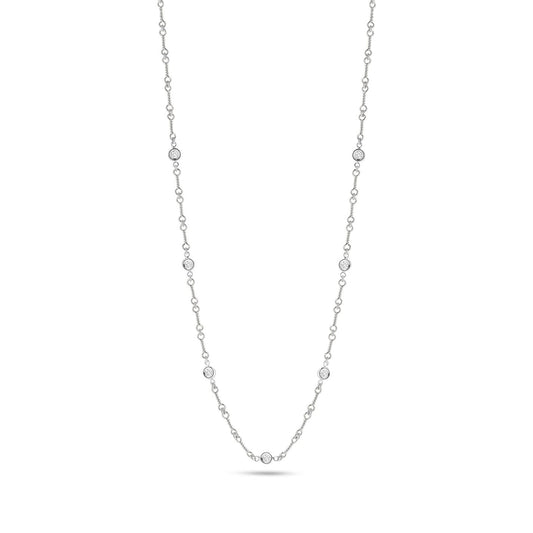 Explore the sophistication of the Roberto Coin Diamonds By The Inch 18K White Gold Seven Station Necklace. This exquisite necklace features evenly spaced round diamonds along a luxurious 18 karat white gold chain, beautifully accentuated against a pure white backdrop.