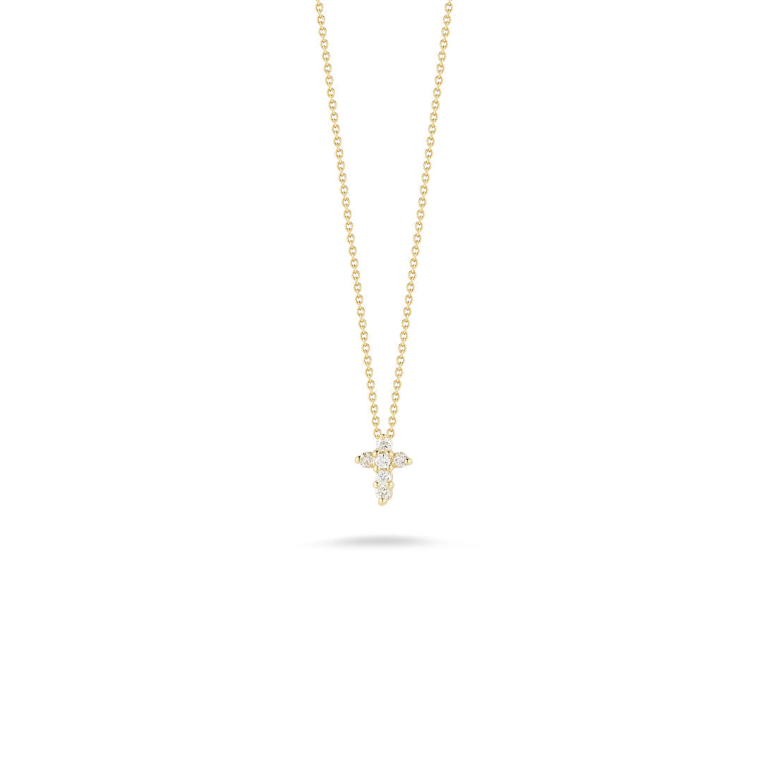 The Roberto Coin Tiny Treasures 18K Yellow Gold Diamond Baby Cross Necklace Pendant features a delicate gold chain and a small cross-shaped pendant adorned with sparkling diamonds, beautifully showcased against a plain white background.