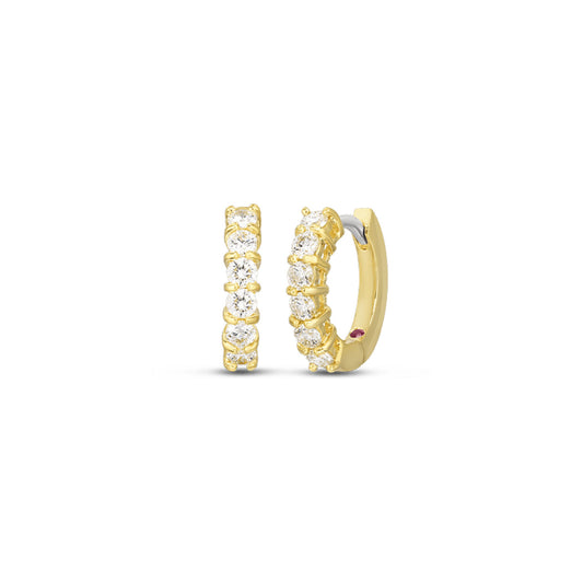 The Roberto Coin Perfect Diamond 18K Yellow Gold Huggie Diamond Earrings, part of the exquisite Diamond Collection, are shown against a plain white background with one earring presented from the front and the other from the side, each adorned with sparkling white gemstones.