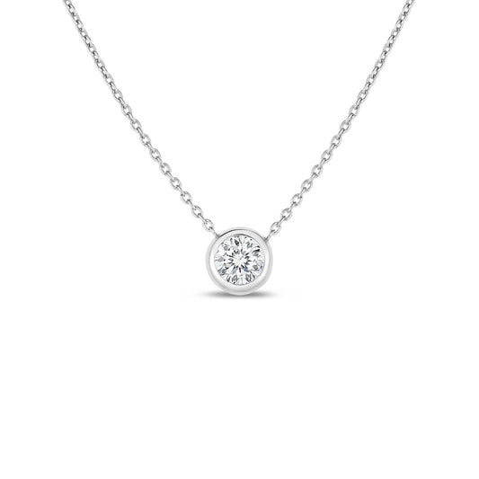 This stunning creation from Roberto Coin, the Diamonds By The Inch Collection, showcases a delicate necklace featuring a solitaire diamond pendant elegantly bezel set in 18K white gold, all highlighted against a pristine white background.