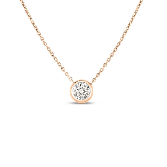 The Roberto Coin Diamonds By The Inch necklace features a refined 18K Rose Gold chain and a captivating round, bezel-set diamond pendant. This elegant piece from Roberto Coin shines beautifully against a simple white backdrop, making it perfect for any occasion.