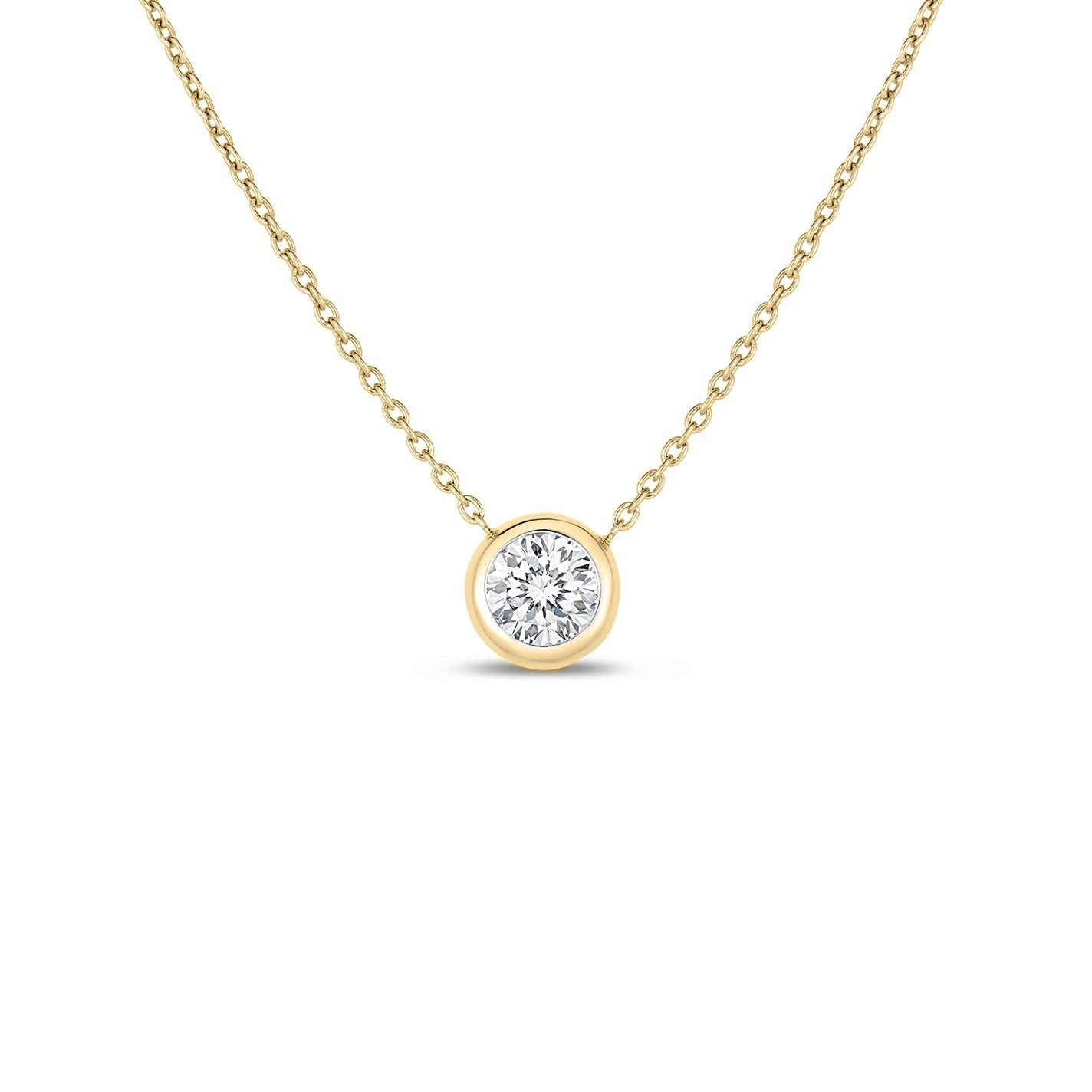 This exquisite Roberto Coin necklace, from the Diamonds By The Inch collection, showcases a solitaire pendant with a brilliant-cut diamond set in a simple bezel on an 18K yellow gold chain. The understated elegance of this piece is highlighted by the diamond's radiant shine.