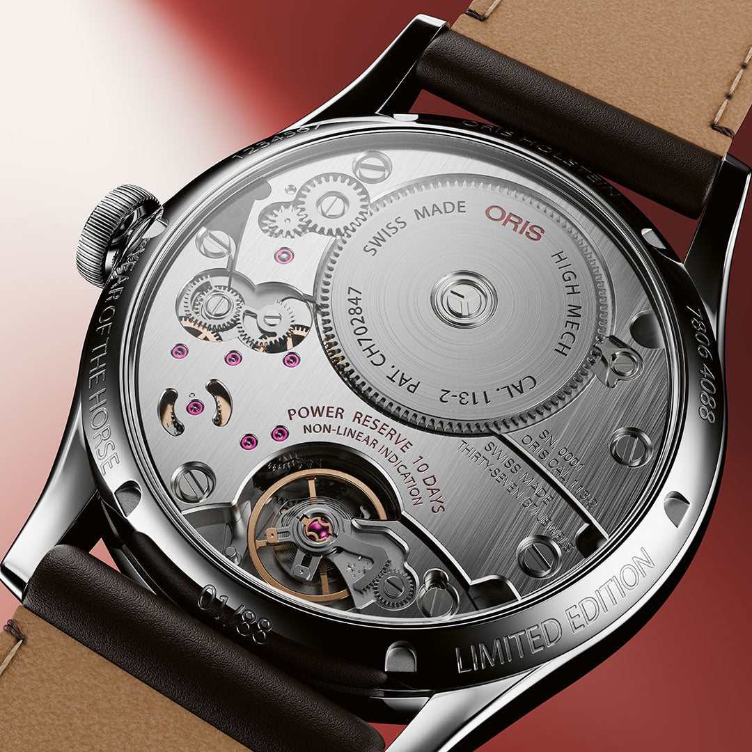 Close-up of the back of the ORIS Artelier Year of the Horse Automatic 43mm Watch Limited Edition of 88 Pieces, highlighting intricate gears, screws, and engraved markings on its brushed metal surface.