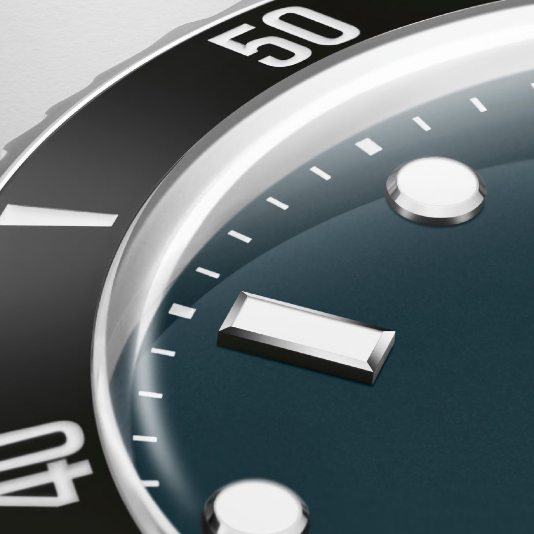 Close-up of the ORIS Divers Date Calibre 733-1 Automatic Winding 39mm Watch shows its ceramic bezel with numbers 40 and 50, blue dial with white hour markers, and metal edge, highlighting the brand's precision and design.