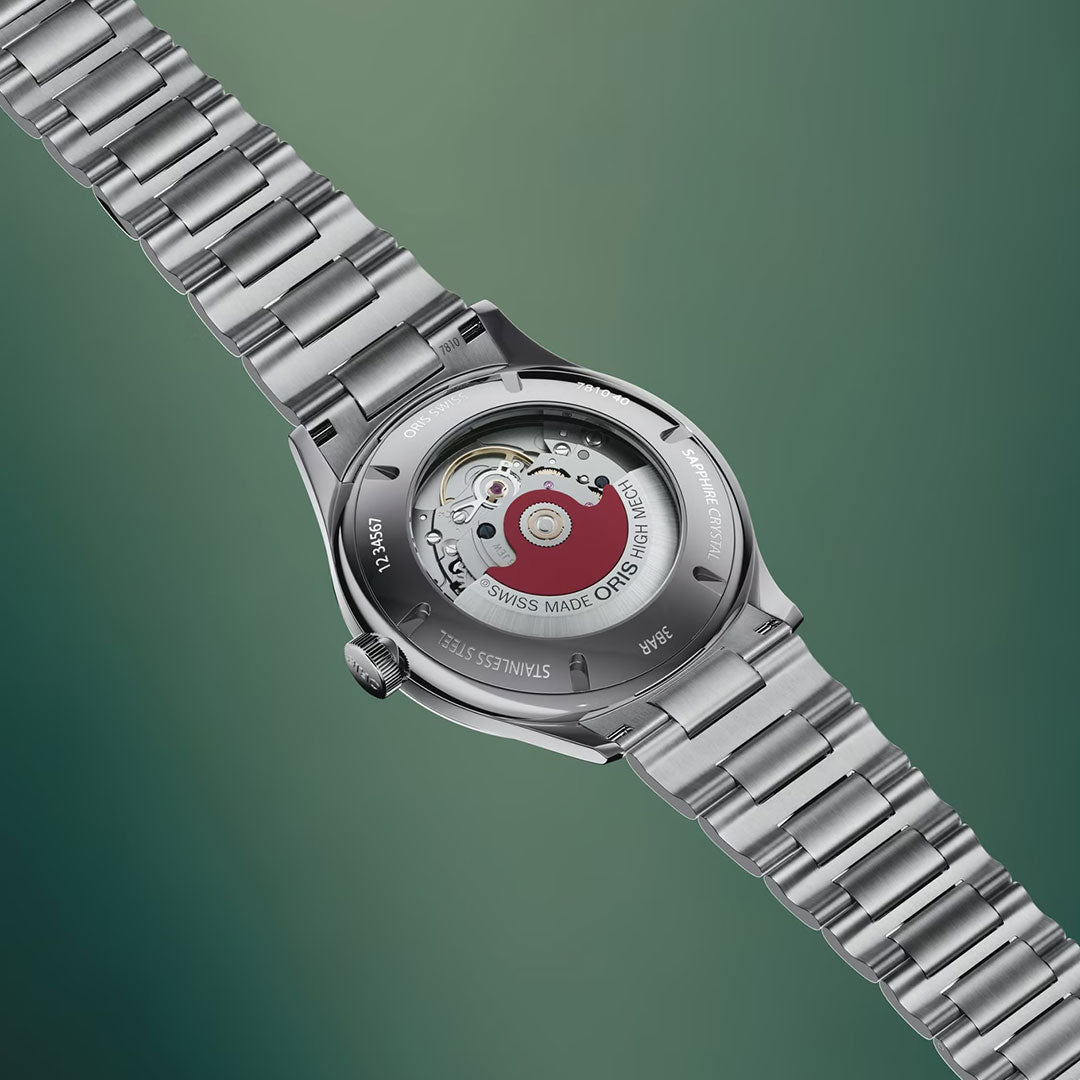 The ORIS Artelier Date Calibre 733-1 Automatic 38mm Watch is displayed from the back, showcasing its transparent case and visible Swiss mechanical movement against a green gradient background.