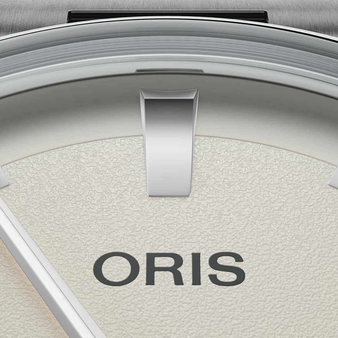 Close-up of the ORIS Artelier Date Calibre 733-1 Automatic 38mm watch face, featuring a textured off-white background, bold silver hour marker, visible watch hand detail, and "ORIS" branding, highlighting Swiss-made automatic movement.