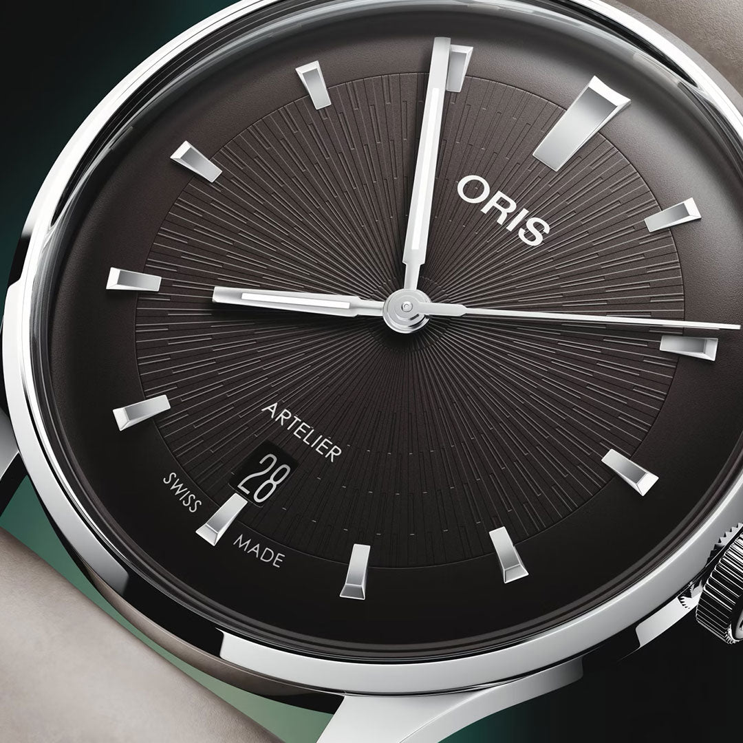 Close-up of the ORIS Artelier Date Calibre 733-1 Automatic 38mm watch, featuring a dark sunburst dial, silver markers and hands, date window at 6 o’clock, and "ORIS," "ARTELIER," and "SWISS MADE" on the Swiss mechanical timepiece.