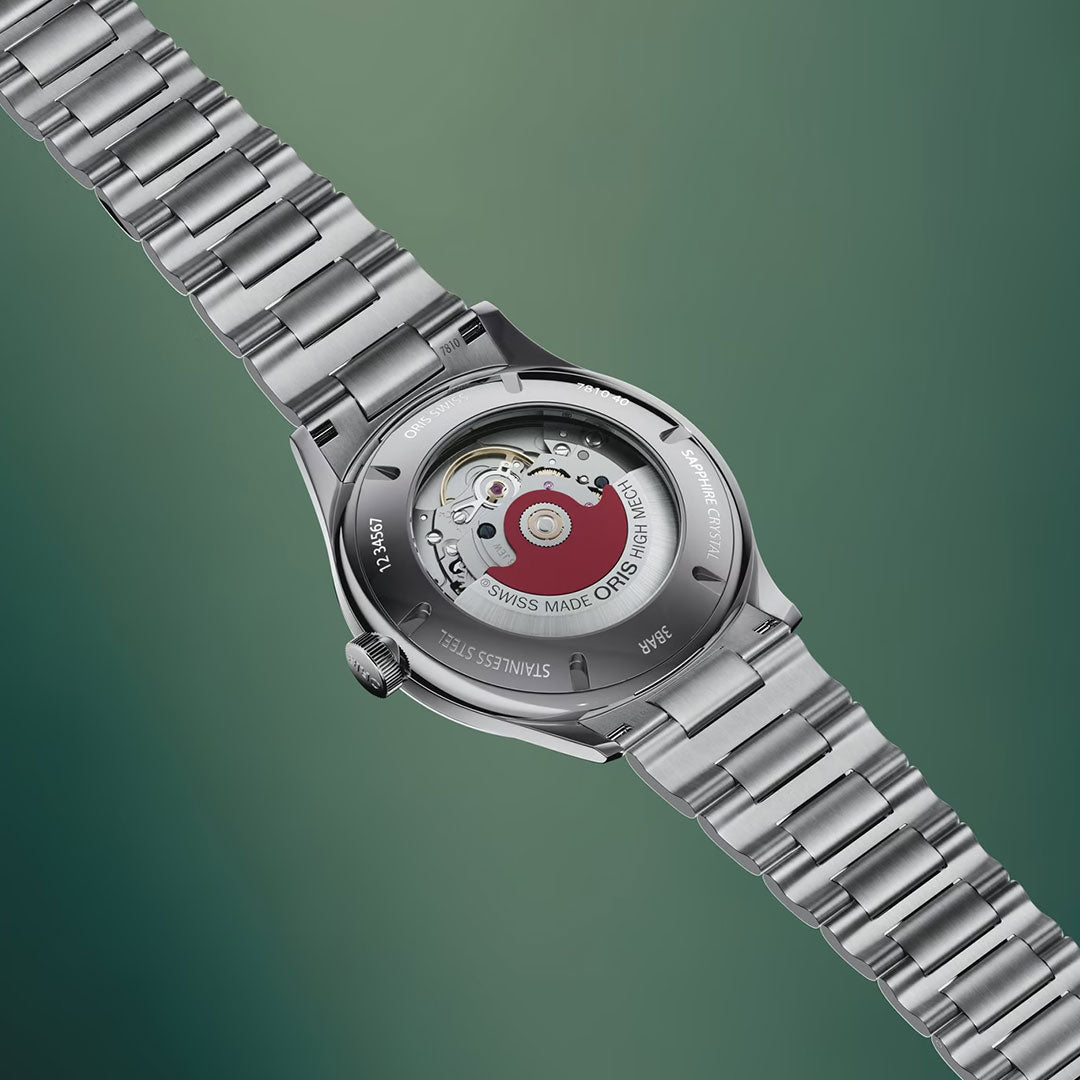 A close-up of the ORIS Artelier Date Calibre 733-1 Automatic 38mm Watch’s caseback reveals its red rotor and visible movement, with Swiss made and stainless steel engravings, set against a green gradient background.