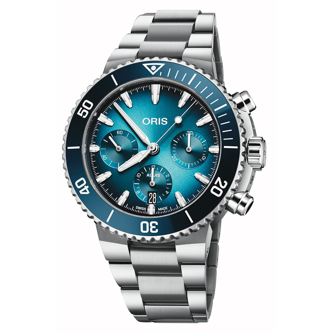 The ORIS Aquis Chronograph Automatic 43.5mm Watch features a teal blue dial with three subdials, date at 6 o’clock, a black unidirectional bezel, and stainless steel bracelet—combining performance with style.