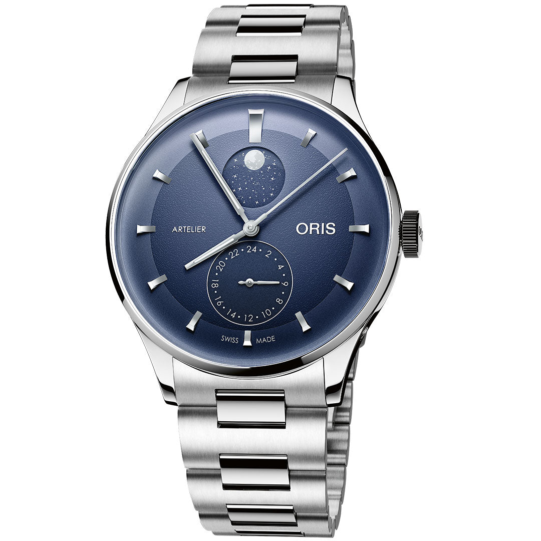 The ORIS Artelier Complication Calibre 782 Automatic 39.5mm features a blue dial with silver markers, moon phase at 12 o’clock, date subdial at 6 o’clock, and a polished metal bracelet for a modern look.