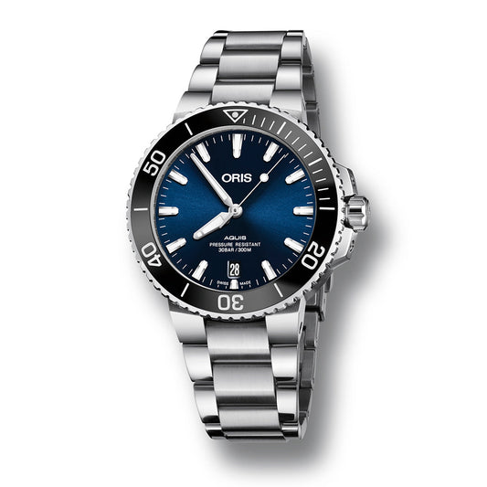 The ORIS Aquis Date Automatic Winding 39.5mm Watch is an impressive silver dive watch that showcases a dark blue dial and a stainless steel case with a bracelet. Its diving bezel is detailed with numerals and a top triangle, while the dial features luminescent markers, hands, and a date window at the 6 o'clock position.