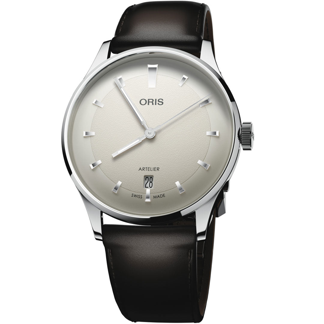 The ORIS Artelier Date Calibre 733-1 Automatic 38mm Watch features a cream dial with silver markers, date at 6 o’clock, black leather strap, and a polished silver case. The dial displays “Oris” and “Artelier.”.