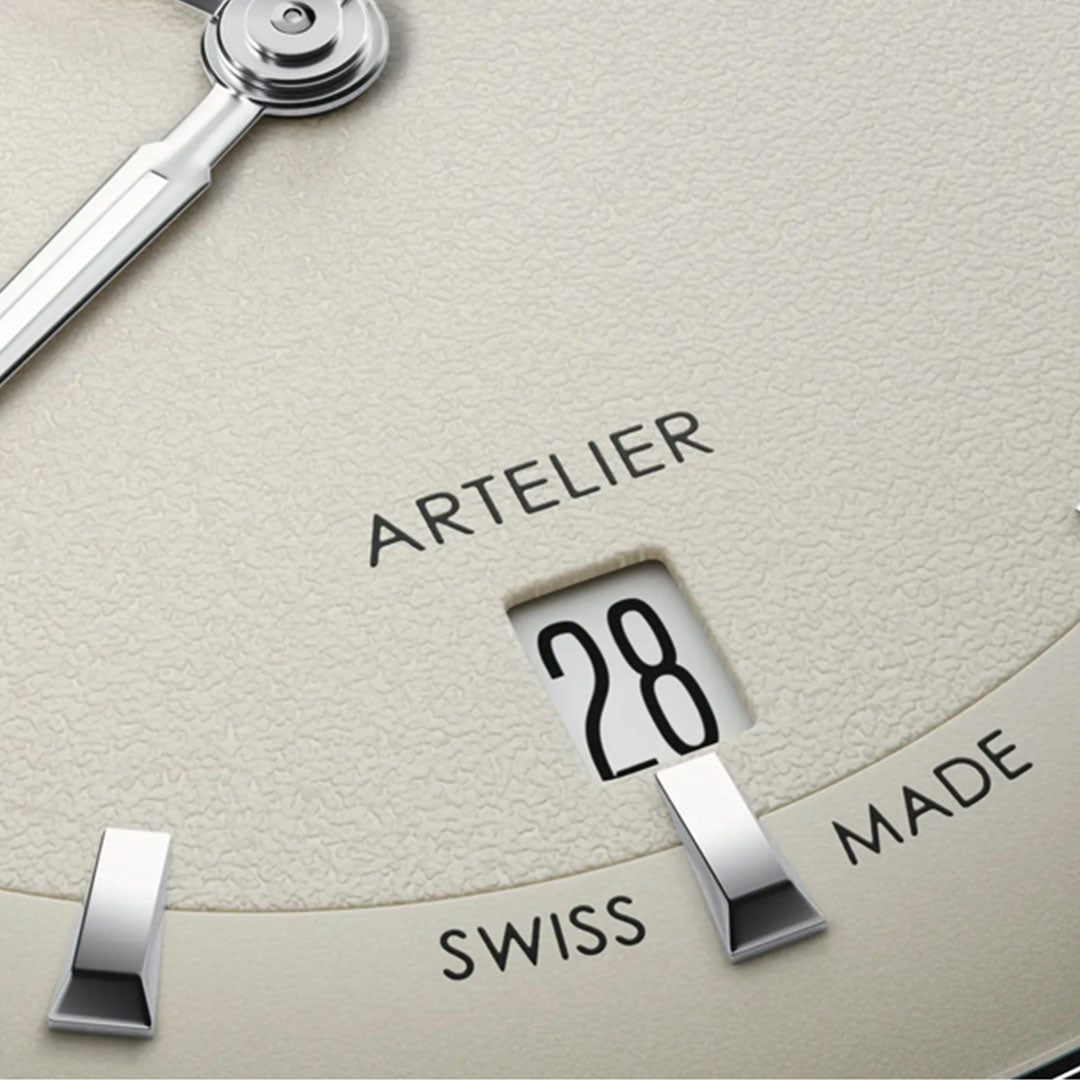 Close-up of the ORIS Artelier Date Calibre 733-1 Automatic 38mm Watch face showing "ARTELIER," "SWISS MADE," the date at 28, and a textured dial with partial watch hand and hour markers, reflecting classic ORIS design.