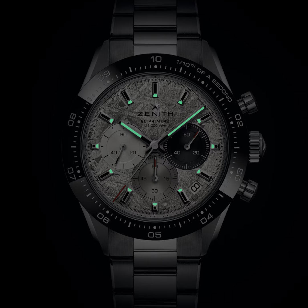 The Zenith Chronomaster Sport El Primero 3600 Automatic Chronograph 41mm watch features a textured dial, luminescent hands and markers, and three subdials, displayed here against a dark background.