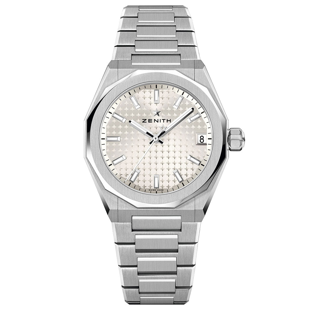 The Zenith Defy Skyline 36 Elite 670 Automatic 36mm Watch features a stainless steel case, silver-toned dial, silver bracelet, silver markers and hands, date at 3 o’clock, and an octagonal bezel.
