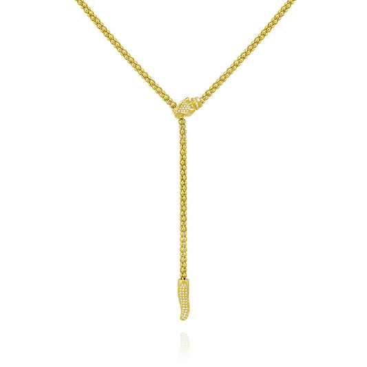 The Miss Mimi Lioness Red Eye 18K Yellow Gold Vermeil Lariat Necklace from Miss Mimi by Yael features a textured chain with a lariat style. It includes an elongated drop with a loop and teardrop-shaped end, both embellished with small sparkling stones. Measuring 52cm in length, it is elegantly displayed against a plain white background.