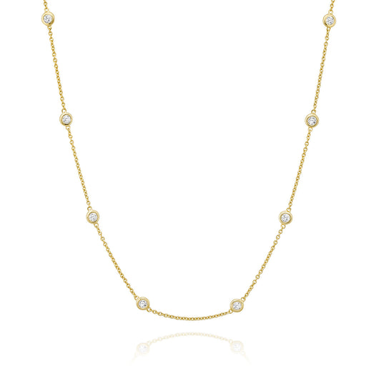 The Miss Mimi by Yael 18K Yellow Gold Vermeil and Sterling Silver Cubic Zirconia Station Necklace features a minimalist and elegant design, with evenly spaced cubic zirconia accents delicately adorning the slender chain. Displayed on a plain white background, it exudes understated sophistication.