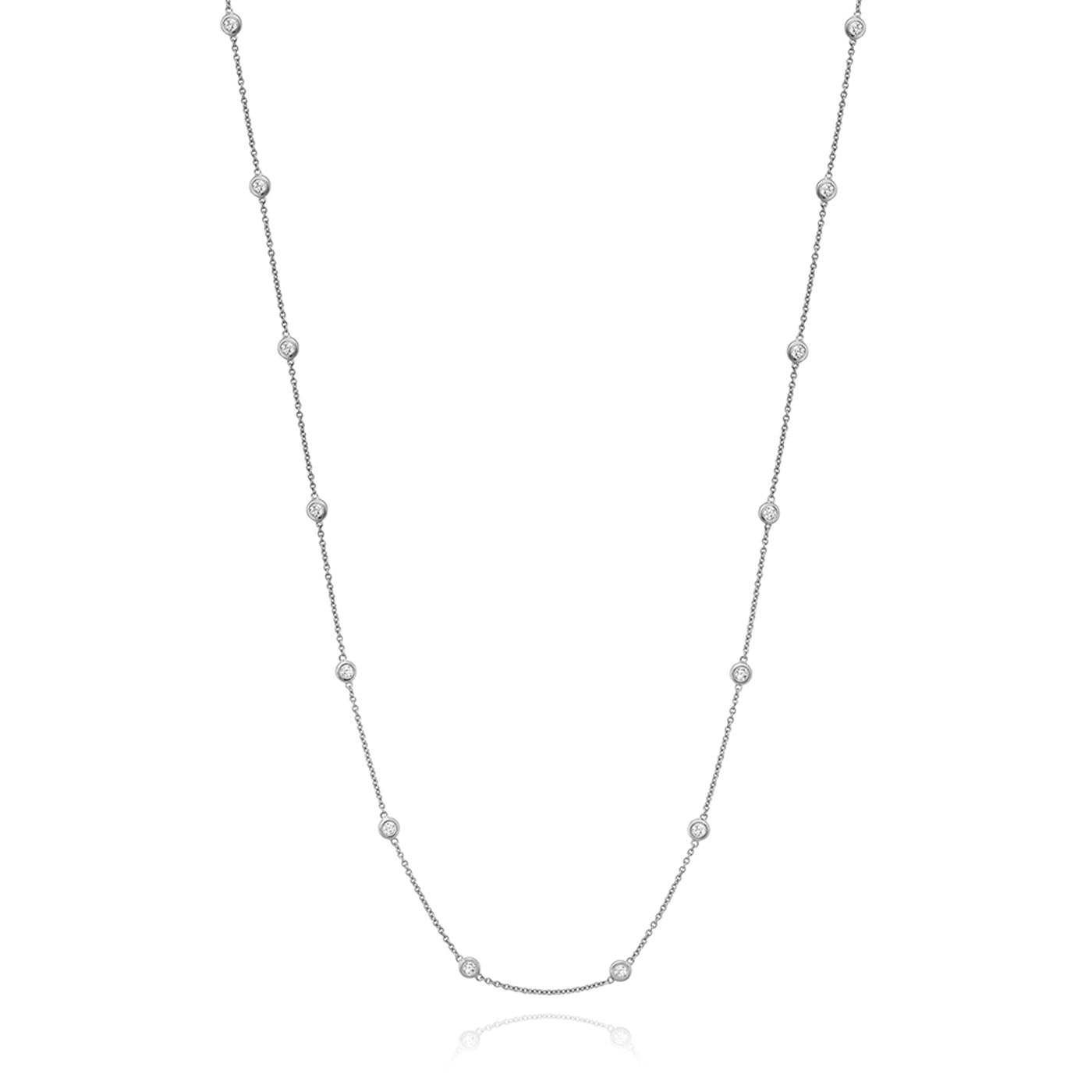 The Miss Mimi by Yael Sterling Silver Cubic Zirconia Station Necklace boasts a delicate sterling silver chain accented with small, round cubic zirconia evenly spaced along its length. Its minimalist and elegant design makes it perfect for various occasions.