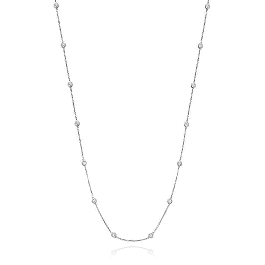 The Miss Mimi by Yael Sterling Silver Cubic Zirconia Station Necklace boasts a delicate sterling silver chain accented with small, round cubic zirconia evenly spaced along its length. Its minimalist and elegant design makes it perfect for various occasions.