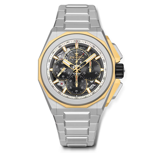 The ZENITH Defy Extreme El Primero 9004 45mm Watch features a silver and gold case and strap, a black chronograph dial with gold accents, subdials, and a tachymeter. The Zenith brand name is prominently displayed. Discover this marvel at ZENITH boutiques.