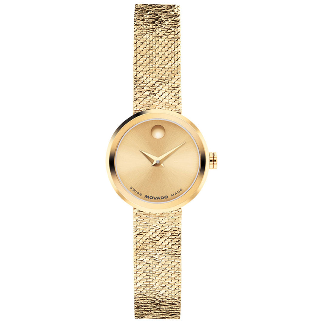 The Movado Veluran Mini Quartz 21mm Watch by Movado features a minimalist round yellow gold dial with a single signature dot at 12 o’clock, gold hour and minute hands, and a textured Milanese mesh bracelet. This elegant women’s wristwatch is powered by precision Swiss-made quartz movement.