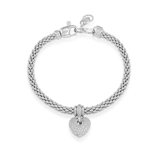 The Miss Mimi by Yael Sterling Silver Puffed Pave Heart Mesh Bracelet features a braided design and a lobster clasp, showcasing a sparkling heart-shaped charm adorned with cubic zirconia. Crafted in Italy, it represents the perfect blend of elegance and craftsmanship.