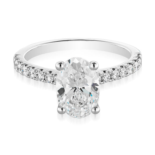 Introducing the Raffi&Co.® 14K White Gold Oval Solitaire Lab Centre Diamond Engagement Ring. This exceptional ring features a stunning oval solitaire lab centre diamond held in a four-prong setting, complemented by smaller round brilliant mined accent diamonds on the band to enhance its sparkle and sophistication.