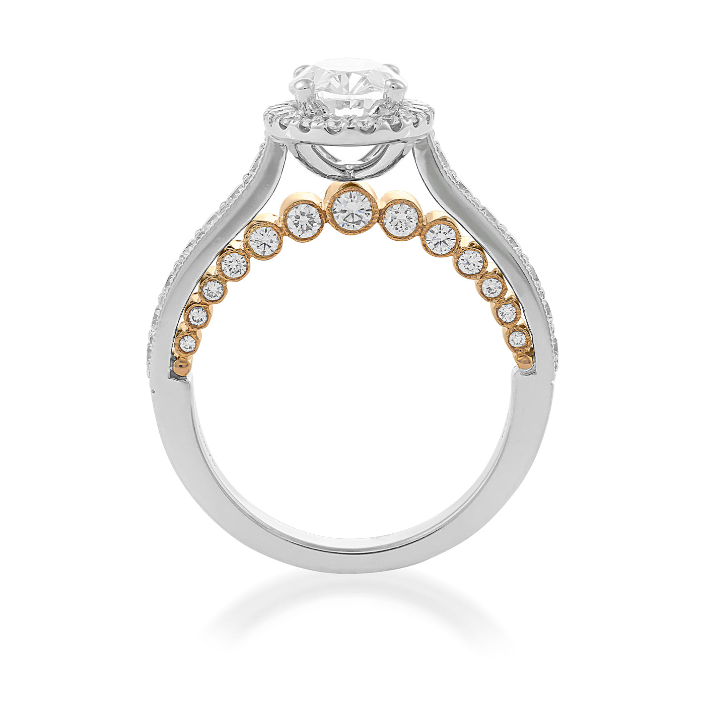 Introducing the Raffi&Co.® 18K Yellow and White Gold Oval Halo Diamond Engagement Ring, an elegant creation from Raffi&Co that features a silver and gold band adorned with small round diamonds. This exquisite piece showcases a crown-like prong setting for its round diamond centerpiece, beautifully capturing the essence of an oval halo diamond engagement ring style.