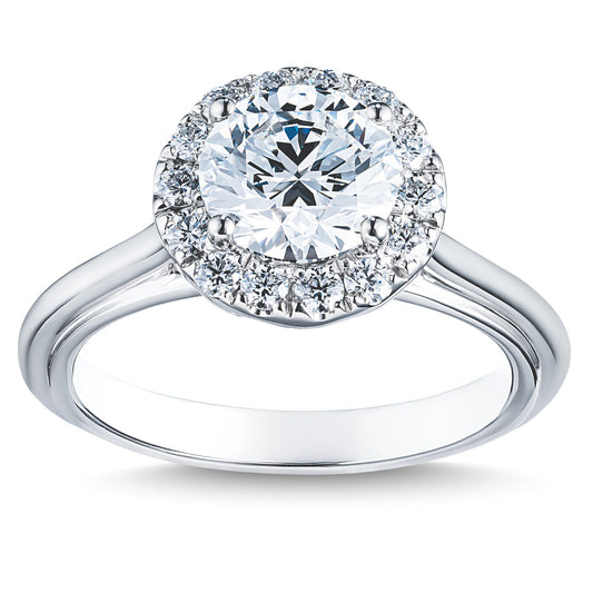 The Raffi&Co.® 14K White Gold Round Brilliant Diamond Halo Engagement Ring features a large round diamond at its center, encircled by a halo of smaller diamonds on a smooth and polished band.