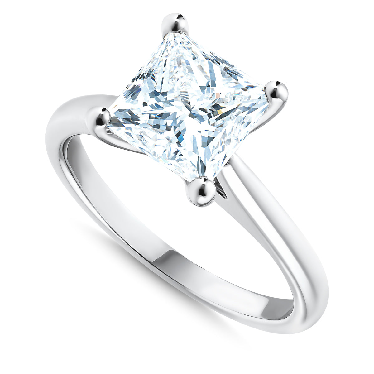 A close-up of the Raffi&Co.® 18K White Gold Princess Solitaire Diamond Engagement Ring shows its large princess solitaire diamond elegantly set in a four-prong mount. The ring is highlighted by a sleek, smooth band with a reflective surface.