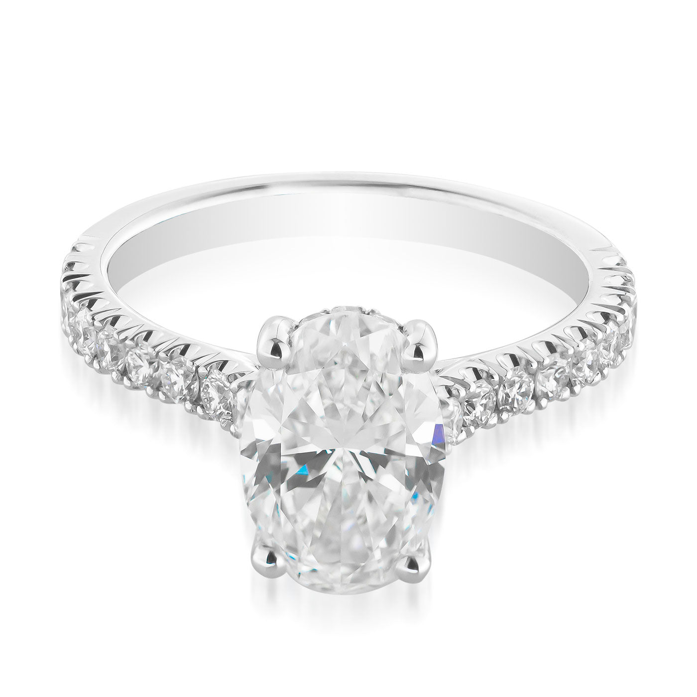 This exquisite Raffi&Co.® Signature engagement ring features a stunning oval diamond at its center, enhanced by a hidden halo and a band accented with smaller diamonds for added elegance and sparkle. Crafted from 18k white gold, it exudes luxury and timeless beauty.