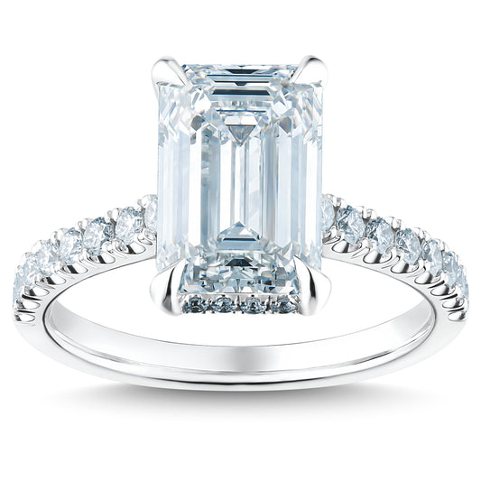 Experience the elegance of the Raffi&Co.® 14K White Gold Emerald Hidden Halo Diamond Engagement Ring, showcasing a large rectangular emerald-cut diamond at its center, set on a platinum band adorned with smaller round diamonds for added sophistication.