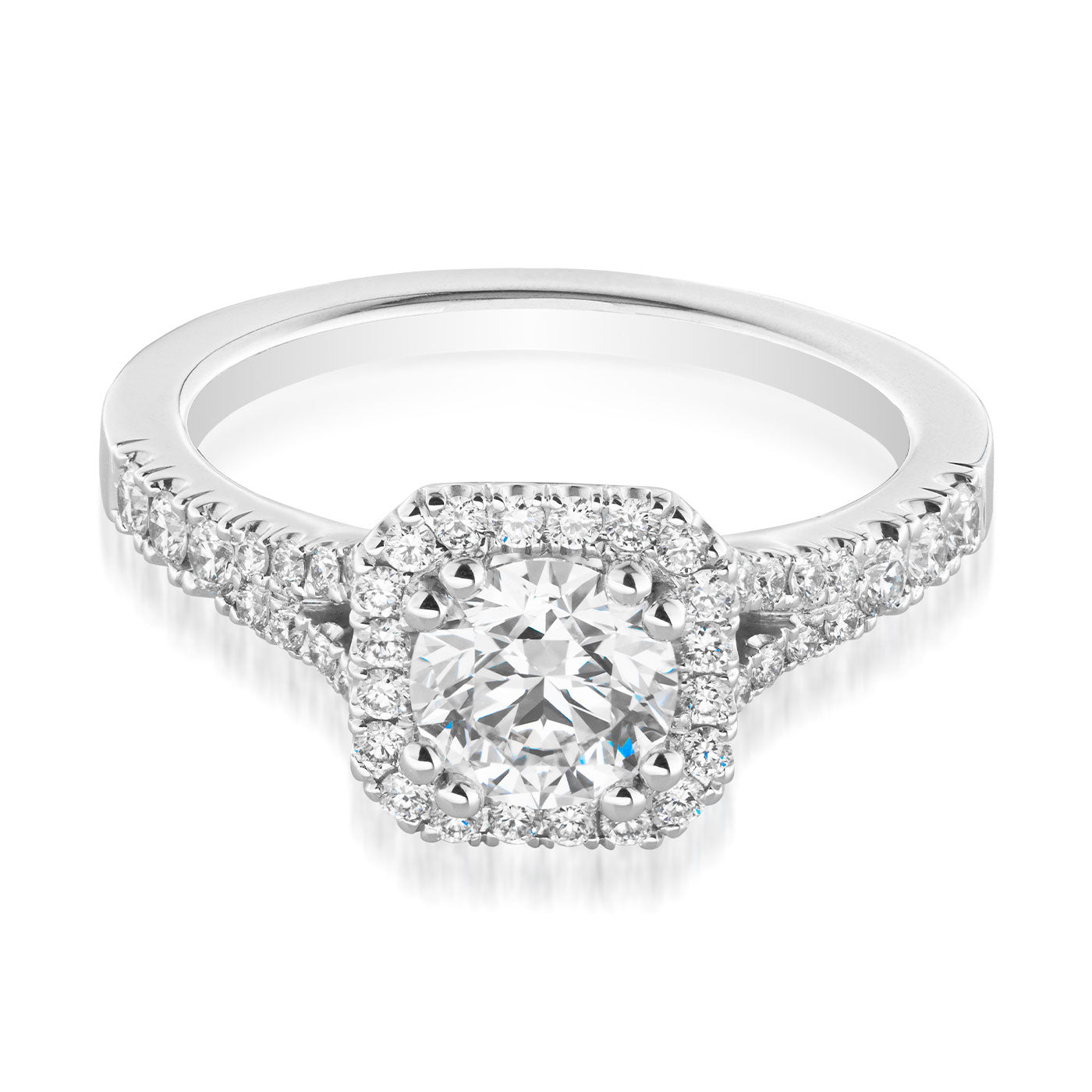 Introducing the Raffi&Co.® Signature 14K White Gold Round Brilliant Halo Diamond Engagement Ring, a breathtaking piece crafted by Raffi&Co that showcases a large round diamond centerpiece encircled by smaller diamonds in an exquisite halo setting. The band is embellished with additional stones, amplifying its sparkle and elegance.