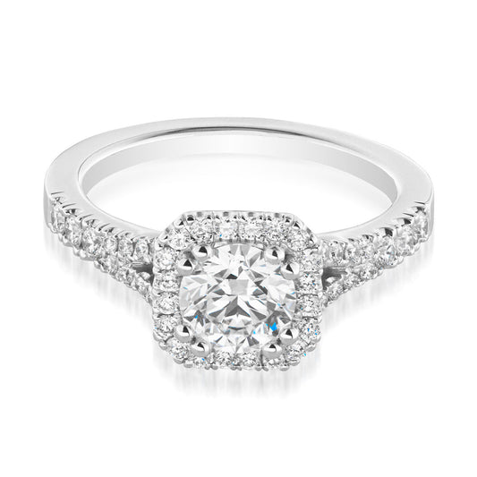 Introducing the Raffi&Co.® Signature 14K White Gold Round Brilliant Halo Diamond Engagement Ring, a breathtaking piece crafted by Raffi&Co that showcases a large round diamond centerpiece encircled by smaller diamonds in an exquisite halo setting. The band is embellished with additional stones, amplifying its sparkle and elegance.