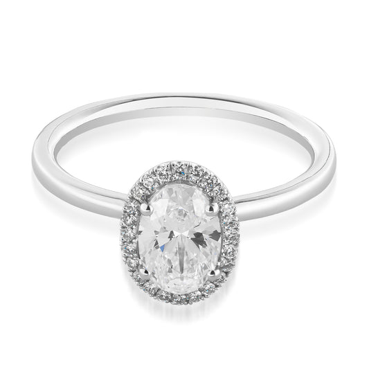 The Raffi&Co.® 14K White Gold Oval Halo Diamond Engagement Ring showcases a central oval-shaped diamond, encircled by a halo of accent diamonds, and is elegantly set on a sleek band.