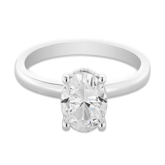 The Raffi&Co® 18K White Gold Oval Hidden Halo Diamond Engagement Ring showcases an exquisite oval-cut diamond in a four-prong setting. This GIA-certified gem from Raffi&Co captivates with its timeless charm and sophistication.