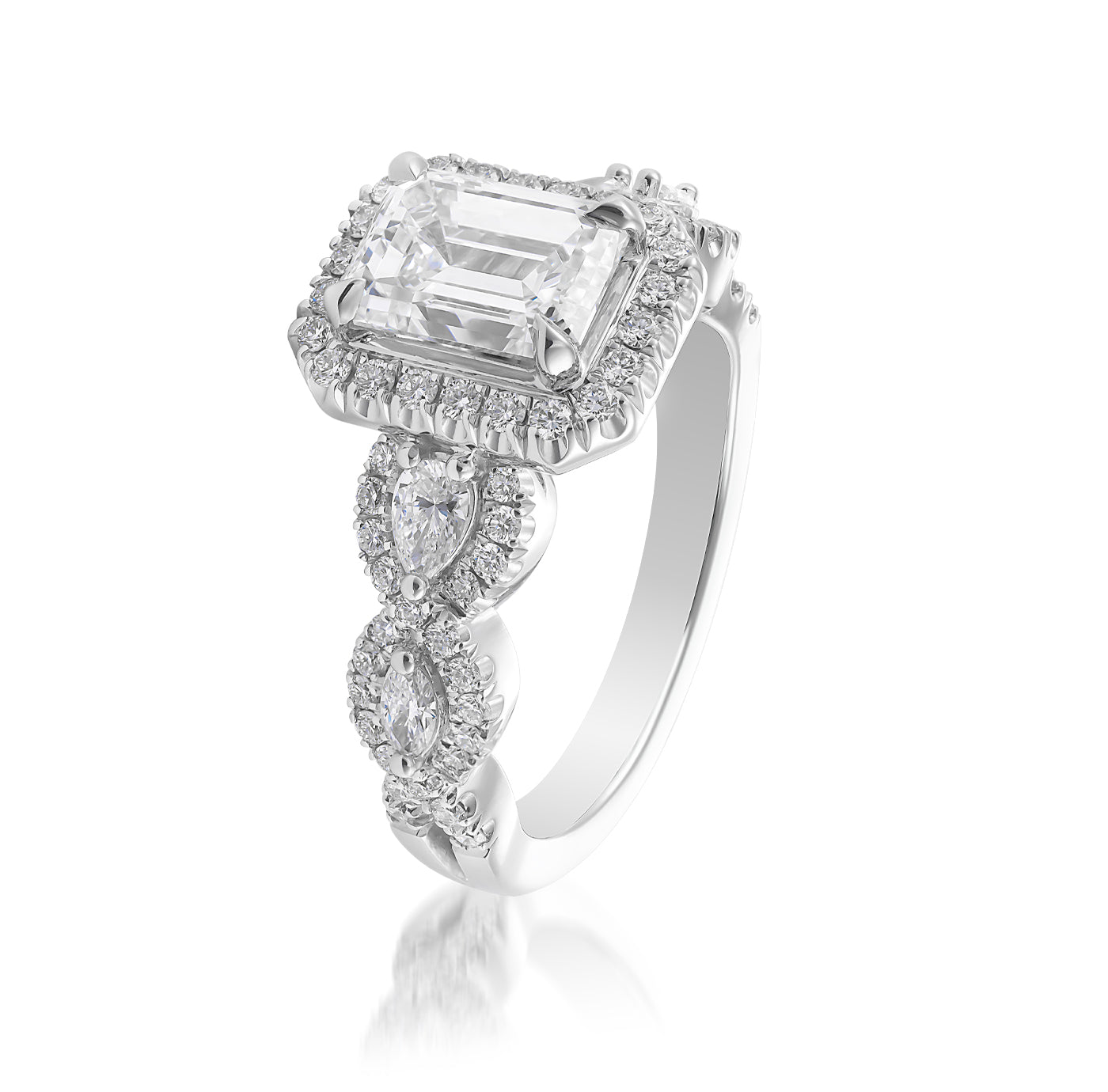 The Raffi&Co.® 14K White Gold Emerald Halo Diamond Engagement Ring showcases a breathtaking emerald halo engagement centerpiece. It features a rectangular emerald-cut, GIA-certified diamond surrounded by smaller diamonds and an elegant band adorned with two pear-shaped diamonds accented by additional sparkling stones, creating an ornate design.