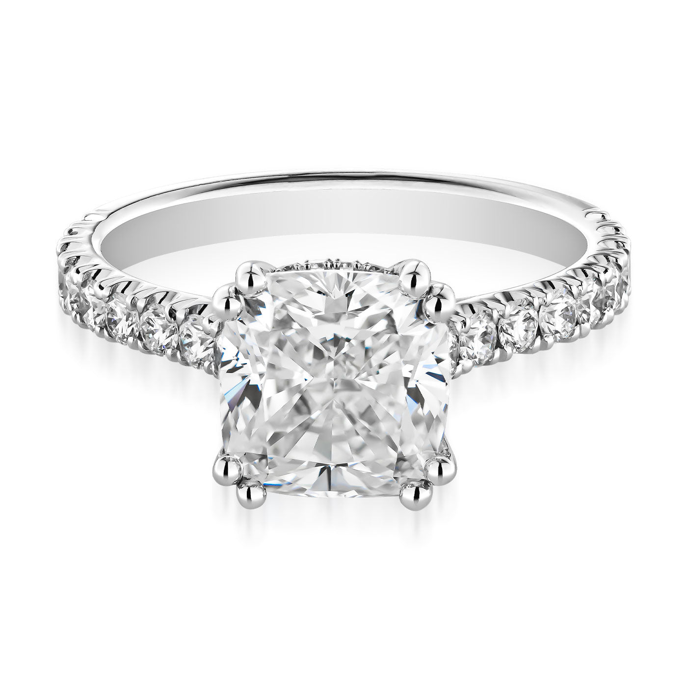 Introducing the Raffi&Co.® 14K White Gold Cushion Hidden Halo Diamond Engagement Ring, an exquisite piece designed by Raffi&Co. This stunning ring showcases a large cushion-cut diamond centerpiece, adorned with small round diamonds on the band in elegant prong settings to enhance the radiant sparkle of each gemstone.